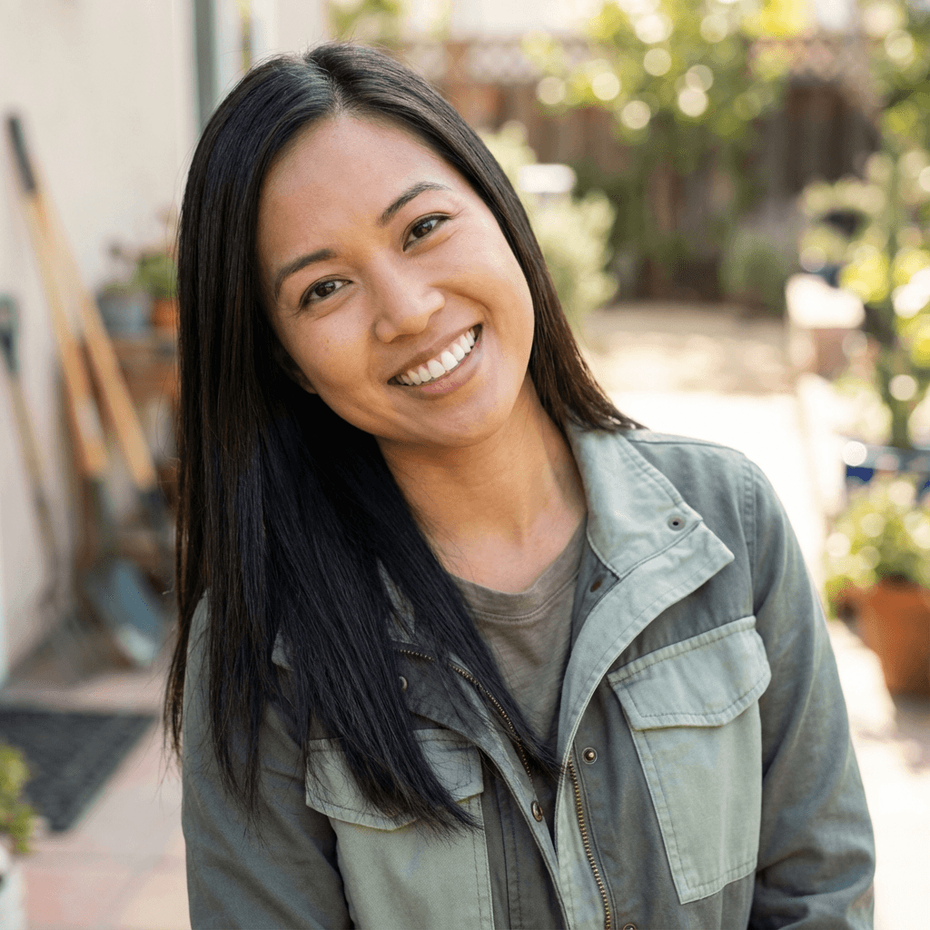 Jessica Cook smiling while organizing project notes and provider lists on her desk